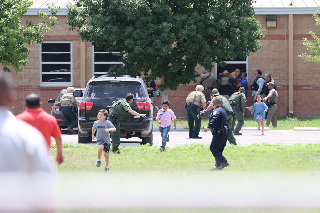 Police and other enforcement agenices rescue terrified students through windows during the Texas school massacre.