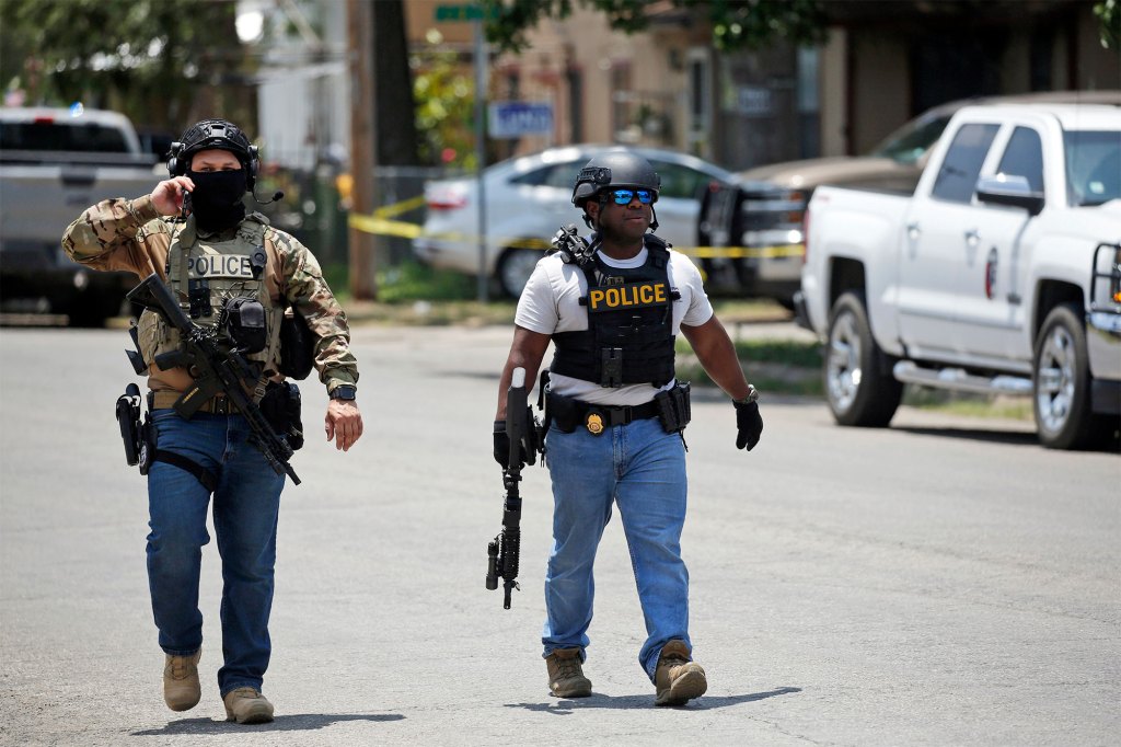 Police walk near Robb Elementary School following the mass shooting on May 24. 