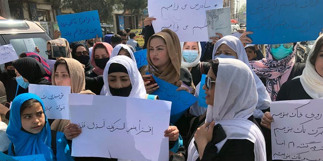 Afghan women chanting and hold signs of protest during a demonstration in Kabul, Afghanistan, March 26.