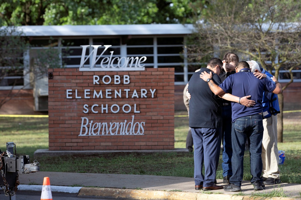 People gather at Robb Elementary School, the scene of a mass shooting in Uvalde, Texas