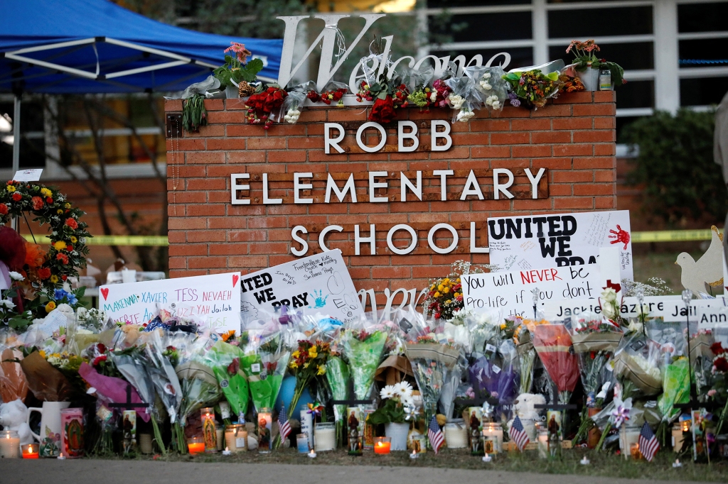 Flowers, candles and signs are left at a memorial for victims of the Robb Elementary school shooting, three days after a gunman killed nineteen children and two teachers, in Uvalde, Texas, U.S. May 27, 2022. REUTERS/Marco Bello
