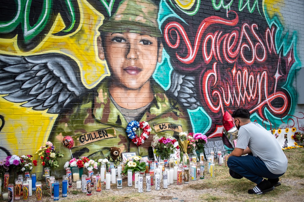 People pay respects at a mural of Vanessa Guillen.