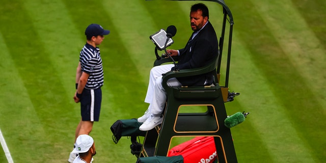 Nick Kyrgios of Australia argues with the umpire after Stefanos Tsitsipas of Greece hit a ball into the crowd during day six of The Championships Wimbledon 2022 at All England Lawn Tennis and Croquet Club on July 02, 2022 in London, England. 