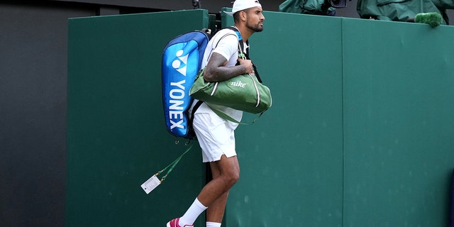 Australia's Nick Kyrgios walks onto court in red trainers on day eight of the 2022 Wimbledon Championships at the All England Lawn Tennis and Croquet Club, Wimbledon. Picture date: Monday July 4, 2022.