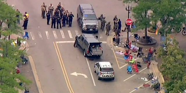 Police deploy after gunfire erupted at a Fourth of July parade route in the wealthy Chicago suburb of Highland Park, Illinois, U.S. July 4, 2022 in a still image from video. 