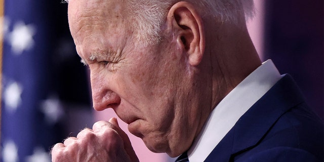 President Biden clears his throat as he announces new steps requiring the government to buy more goods made in America during remarks March 4, 2022. 