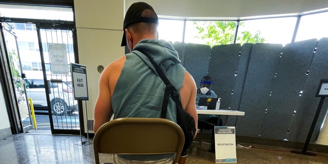 A man awaits his Jynneos vaccine dose as the city launches its first inoculation campaign against monkeypox in Washington, U.S., June 28, 2022. 