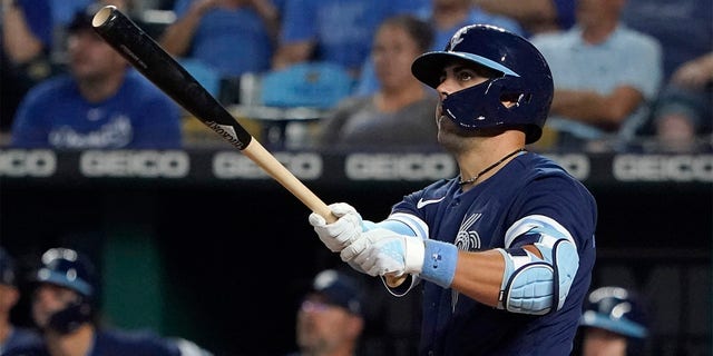 Whit Merrifield #15 of the Kansas City Royals hits a two-run home run in the eighth inning against the Cleveland Guardians at Kauffman Stadium on July 08, 2022 in Kansas City, Missouri. 