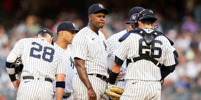 New York Yankees' Luis Severino huddles with teammates during the first inning of the team's baseball game against the Cincinnati Reds on Wednesday, July 13, 2022, in New York. 