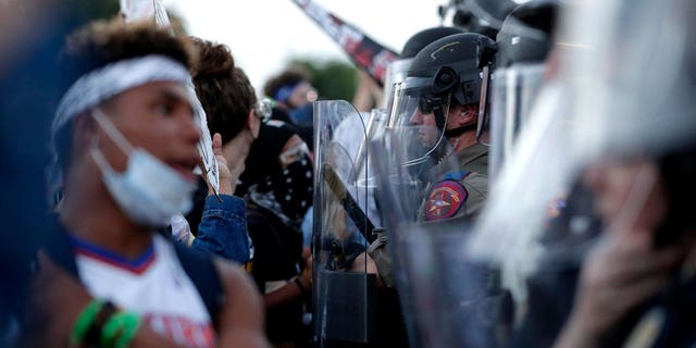 Demonstrators face members of the Austin Police Department as they gather in the downtown area on June 4, 2020, to protest the death of George Floyd.