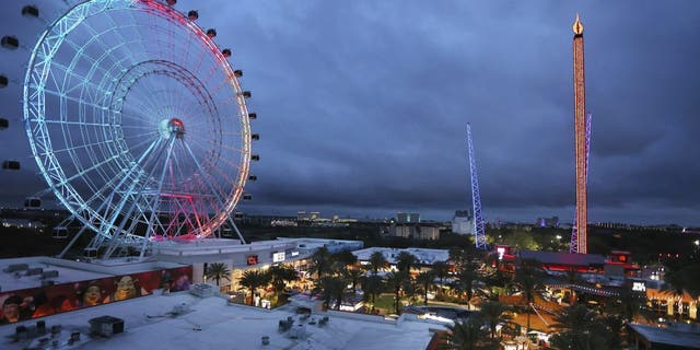 ICON Park attractions, The Wheel, left, Orlando SlingShot, middle, and Orlando FreeFall, right, are shown in Orlando, Fla., on March 24, 2022.