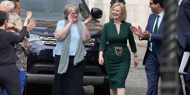 Britain's Secretary of State for Foreign, Commonwealth and Development Affairs, Liz Truss receives applause from her team near Parliament in London, Wednesday, July 20, 2022. 