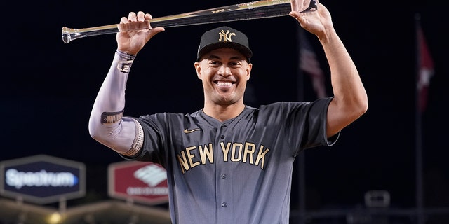 American League's Giancarlo Stanton poses with the Ted Williams Most Valuable Player trophy following the MLB All-Star baseball game, July 19, 2022, in Los Angeles.