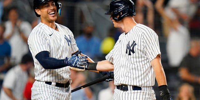 Yankees' Giancarlo Stanton, left, celebrates with DJ LeMahieu during the Cincinnati Reds game on July 13, 2022, in New York.