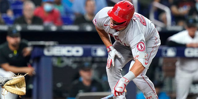 Los Angeles Angels' Mike Trout reacts after being hit by a pitch thrown by Miami Marlins' Trevor Rogers during the fifth inning of a baseball game, Wednesday, July 6, 2022, in Miami. 