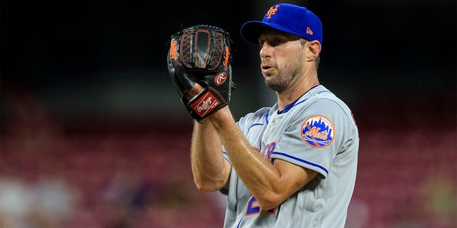 New York Mets' Max Scherzer prepares to throw a pitch during the fifth inning of the team's baseball game against the Cincinnati Reds in Cincinnati, Tuesday, July 5, 2022. 