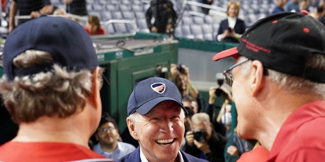 President Biden speaks with members of the Republicans team as he attends the annual Congressional Baseball Game at Nationals Park, Sept. 29, 2021.