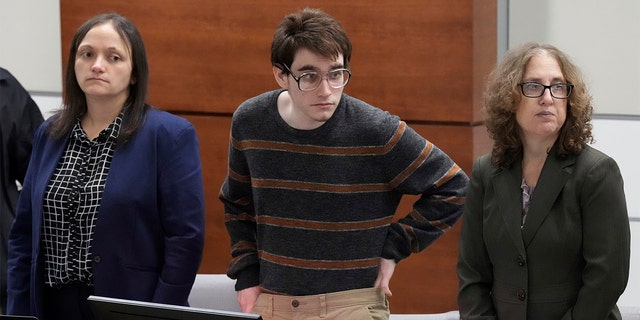 Marjory Stoneman Douglas High School shooter Nikolas Cruz tucks his sweater in while waiting for prospective jurors to enter the courtroom during jury selection in the penalty phase of his trial at the Broward County Courthouse in Fort Lauderdale, Florida.