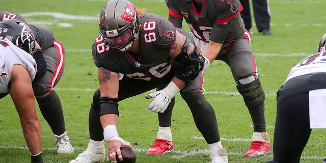 Tom Brady, #12 of the Buccaneers, under center Ryan Jensen, #66, during the regular season game between the Atlanta Falcons and the Tampa Bay Buccaneers on January 03, 2021 at Raymond James Stadium in Tampa, Florida.