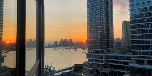 FILE PHOTO: Under-construction apartments are pictured from a building during sunset in the Shekou area of Shenzhen, Guangdong province, China November 7, 2021. 