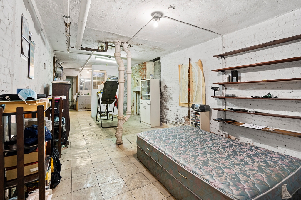Though this space fits a mattress, it's technically the living room, complete with "industrial features," according to the listing description of the space.