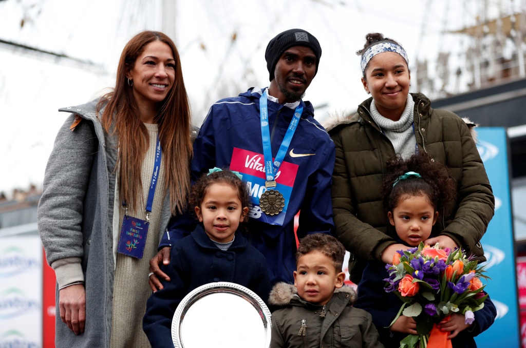 Farah pictured with his wife Tania Nell, her daughter Rhianna, and the pair's three children Hussein, Amani, and Aisha.