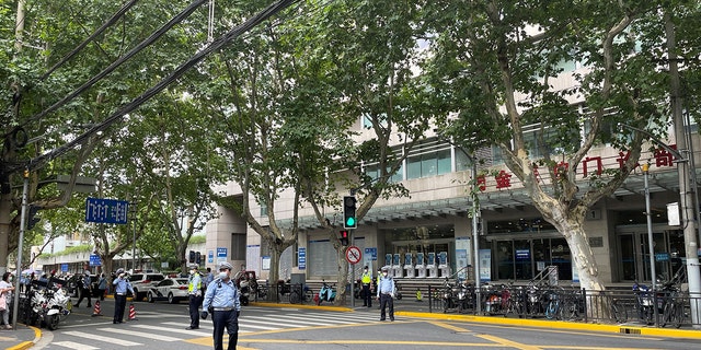 Police officers stand outside the outpatient department of Ruijin Hospital following a stabbing incident, in Shanghai, China July 9, 2022. REUTERS/Brenda Goh