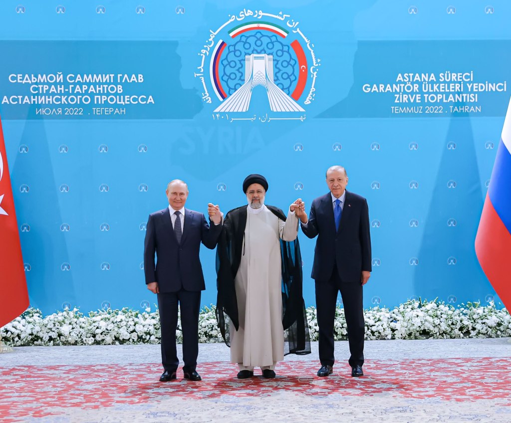 Iranian President Ebrahim Raisi (center), President Vladimir Putin and Turkish President Recep Tayyip Erdogan pose for a photo in Tehran on July 19, 2022. 