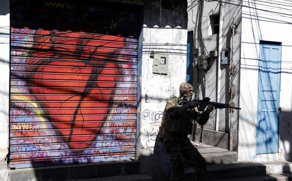 A police officer walks during an operation against drug gangs in Rio de Janeiro, Brazil on July 21, 2022. 