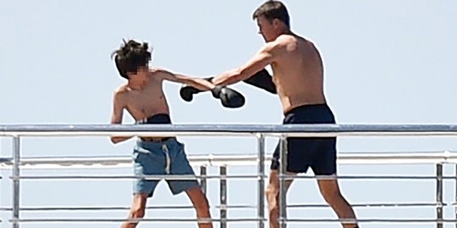 Brady has a training session with his son while vacationing on a yacht in Portofino, Italy. 