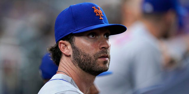 The New York Mets' Tyler Naquin looks out from the dugout during the fifth inning of a game against the Miami Marlins Friday, July 29, 2022, in Miami. New York acquired the left-handed-hitting outfielder and lefty reliever Phillip Diehl Thursday night in a deal for two teenage minor leaguers, outfielder Hector Rodríguez and right-hander Jose Acuña. 