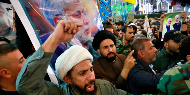 Mourners chant slogans against the U.S. during the funeral of Iran's top general Qassem Soleimani, and Abu Mahdi al-Muhandis, deputy commander of Iran-backed militias in Iraq known as the Popular Mobilization Forces, in the shrine of Imam Hussein in Karbala, Iraq, Saturday, Jan. 4, 2020.