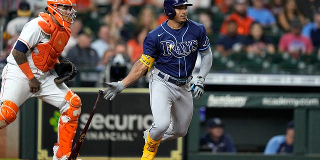 The Tampa Bay Rays' Wander Franco, right, hits into a force out as Houston Astros catcher Martin Maldonado watches during the fourth inning of a game Sept. 30, 2021, in Houston. 