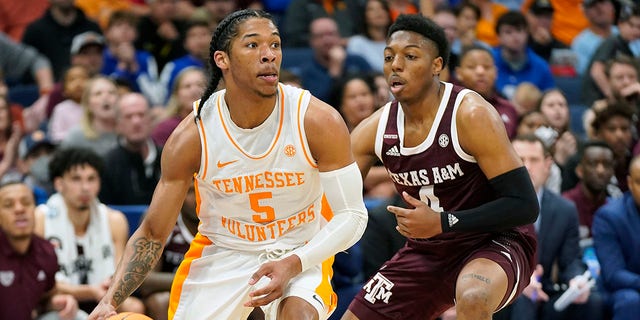 Tennessee guard Zakai Zeigler (5) drives past Texas A&amp;M guard Wade Taylor IV (4) during the first half of an NCAA men's college basketball Southeastern Conference tournament championship game Sunday, March 13, 2022, in Tampa, Fla.