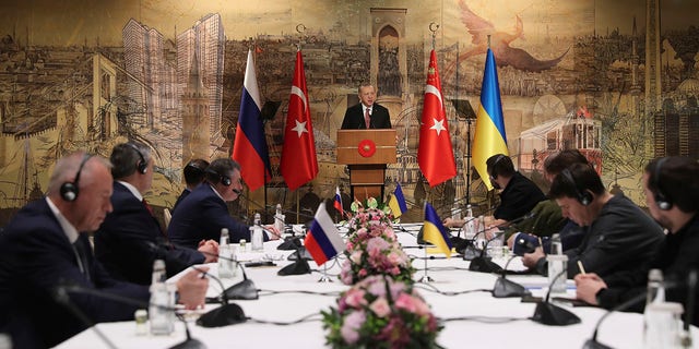 In this photo provided by Turkish Presidency, Turkish President Recep Tayyip Erdogan, center, gives a speech to welcome the Russian, left, and Ukrainian delegations ahead of their talks, in Istanbul, Turkey, Tuesday, March 29, 2022.