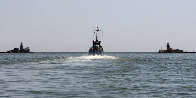 Russian Navy boat of the Black Sea Fleet patrols an aria of the Mariupol Sea Port in Mariupol, in territory under the government of the Donetsk People's Republic, eastern Ukraine, Monday, May 30, 2022. 