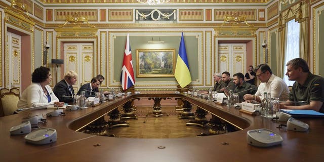 In this image provided by the Ukrainian Presidential Press Office, Britain's Prime Minister Boris Johnson, second left, meets with Ukrainian President Volodymyr Zelenskyy, third right, in Kyiv, Ukraine, Friday, June 17, 2022. (Ukrainian Presidential Press Office via AP)