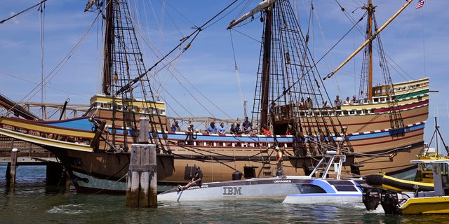 Brett Phaneuf, co-director of the Mayflower Autonomous Ship project, at left, holds a bow line as the Mayflower Autonomous Ship docks next to the replica of the original Mayflower, on Thursday, June 30, 2022, in Plymouth, Mass. The crewless robotic boat retraced the 1620 sea voyage of the Mayflower. 