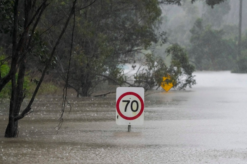 Traffic signs sit submerged along a flooded road in Londonderry on the outskirts of Sydney, Australia.