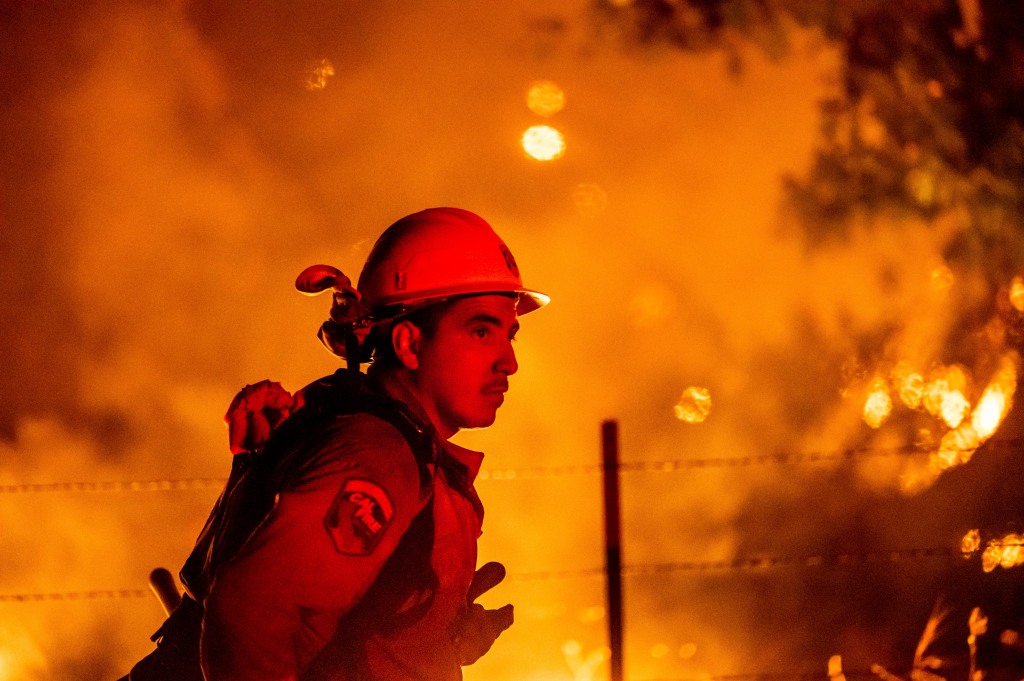 Firefighter Rafael Soto battles the Electra Fire burning in the Rich Gulch community of Calaveras County, Calif.