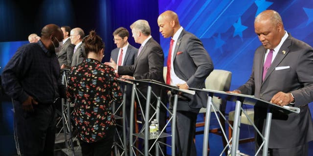 FILE - From right, Rushern Baker, Wes Moore, Doug Gansler and Jon Baron stand at their podiums just before a debate of eight candidates seeking the Democratic nomination for governor of Maryland on Monday, June 6, 2022 in Owings Mills, Md. 