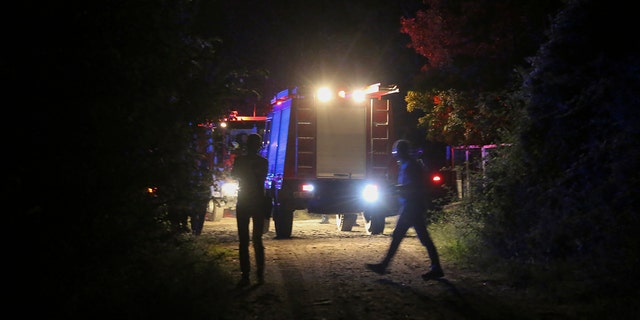 Firefighting vehicles are seen near the site of a plane crash, a few miles away from the city of Kavala, in northern Greece, on Saturday, July 16, 2022.