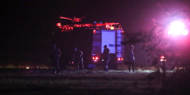 Firefighters are seen near the site of a plane crash, a few miles away from the city of Kavala, in northern Greece, Saturday, July 16, 2022.