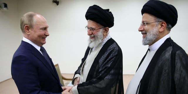 Iranian Supreme Leader Ayatollah Ali Khamenei, center, and Russian President Vladimir Putin, left, greet each other as Iranian President Ebrahim Raisi stands at right, during their meeting in Tehran, Iran, Tuesday, July 19, 2022. 