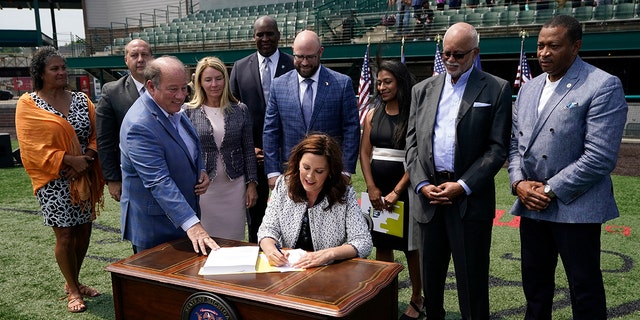 Michigan Gov. Gretchen Whitmer signs the final piece of a $76 billion state budget into law, Wednesday, July 20, 2022, in Detroit. 