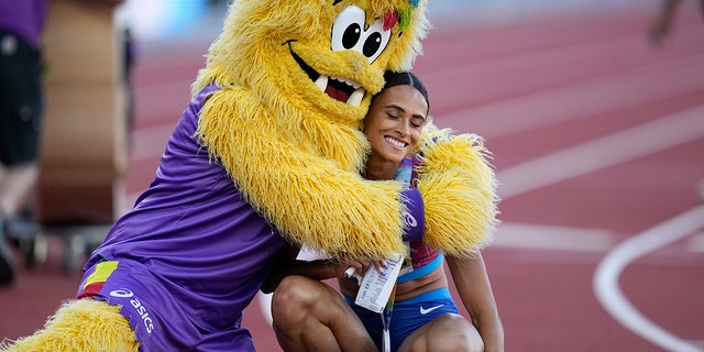 Gold medalist Sydney McLaughlin, of the United States, is embraced after winning the final of the women's 400-meter hurdles at the World Athletics Championships on Friday, July 22, 2022, in Eugene, Ore. 