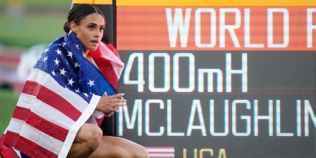 Gold medalist Sydney McLaughlin, of the United States, poses by a sign after winning the final of the women's 400-meter hurdles at the World Athletics Championships on Friday, July 22, 2022, in Eugene, Ore. 