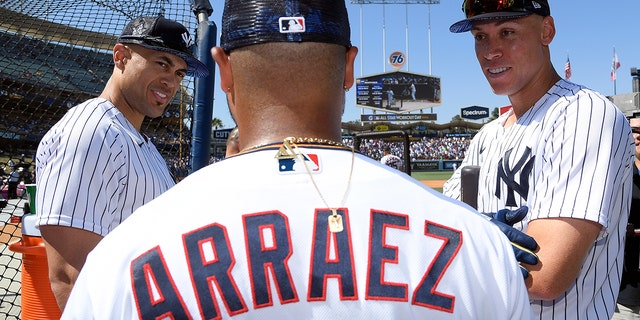 American League All-Stars Giancarlo Stanton #27 (L) and Aaron Judge #99 of the New York Yankees (R) talk with Luis Arraez #2 of the Minnesota Twins during the 2022 Gatorade All-Star Workout Day at Dodger Stadium on July 18, 2022 in Los Angeles, California.