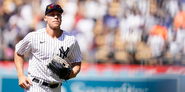 New York Yankees Aaron Judge, left, runs in the outfield during batting practice a day before the 2022 MLB All-Star baseball game, Monday, July 18, 2022, in Los Angeles.