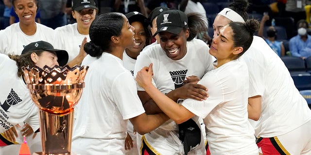 Las Vegas Aces' Chelsea Gray, center, is mobbed by her teammates as she is named MVP of the WNBA Commissioner's Cup basketball game against the Chicago Sky Tuesday, July 26, 2022, in Chicago. The Aces won 93-83. 